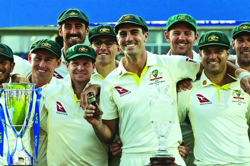 Australia’s Pat Cummins (centre) holds the urn trophy as Australia celebrate retaining the Ashes. (Reuters)