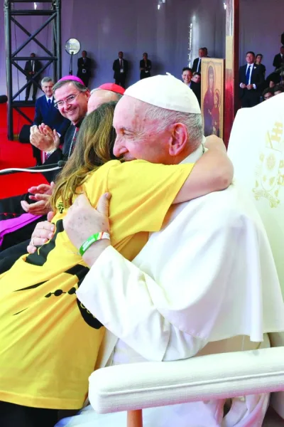 Pope Francis embraces a girl during a meeting with World Youth Day volunteers at Passeio Maritimo during his apostolic journey to Portugal in Alges near Lisbon, Portugal, yesterday. (Reuters)