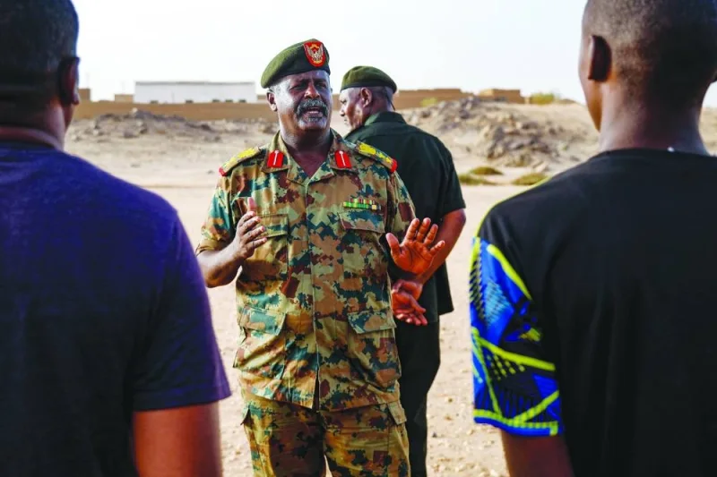 
A Sudanese officer speaks to civilians recruited by the army as they take part in a military training in the Kassinger area. 