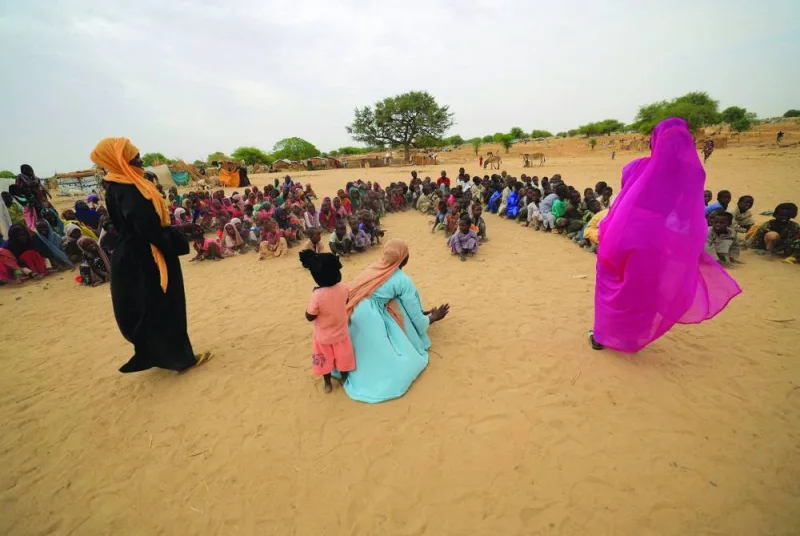 
Zahra Haroun, 19, Nawal Adama, 32, Zahra Mohamed, 20, Sudanese refugee teachers who have fled the 
violence in Sudan’s Darfur region, give their first entertainment and sport training session for refugee children at makeshift shelters near the border between Sudan and Chad in Koufroun, Chad. 