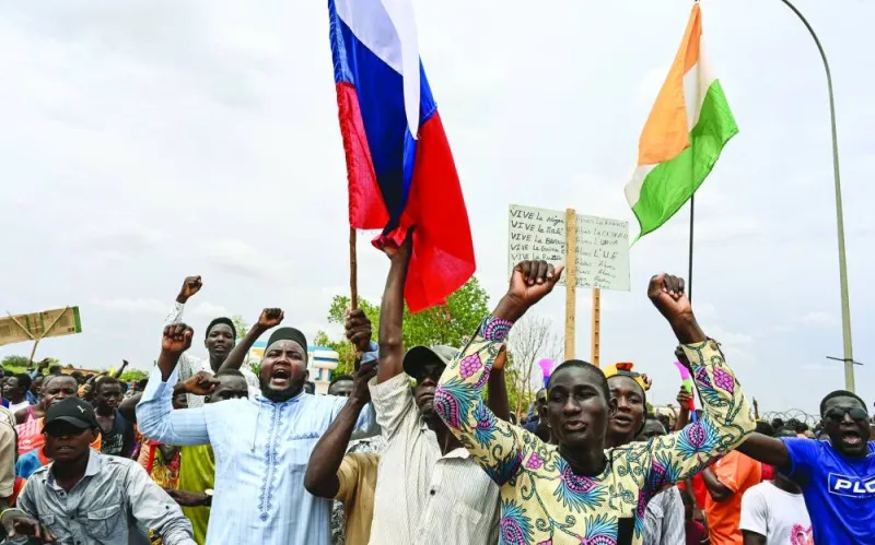 Supporters of Niger’s National Council for the Safeguard of the Homeland (CNSP) hold Niger and Russian flags as they gather for a demonstration in Niamey near a French air base in Niger.