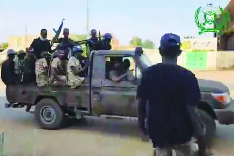 
Members of the Sudanese Armed Forces riding in the back of a pickup truck in central Omdurman. 
