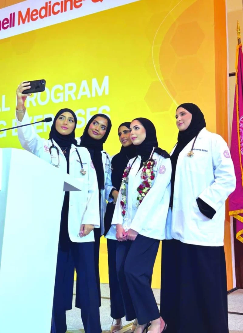 A group of first-year medical students take a selfie at the ceremony.