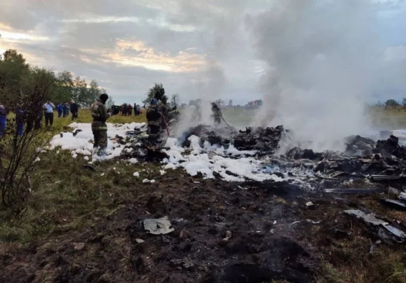 Firefighters work amid aircraft wreckage at an accident scene following the crash of a private jet in the Tver region, Russia, August 23. Investigative Committee of Russia/Handout via REUTERS