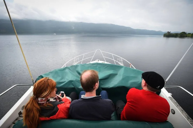 Tourists take a cruise aboard the &#039;Nessie Hunter&#039; boat on Loch Ness in the Scottish Highlands on June 10, 2018. AFP