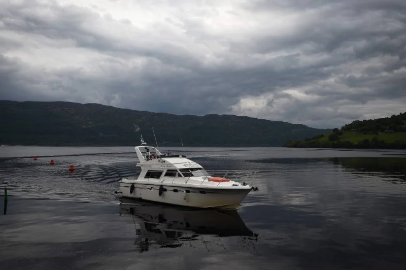 Tourists take a cruise aboard the &#039;Nessie Hunter&#039; boat on Loch Ness in the Scottish Highlands on June 10, 2018.  AFP