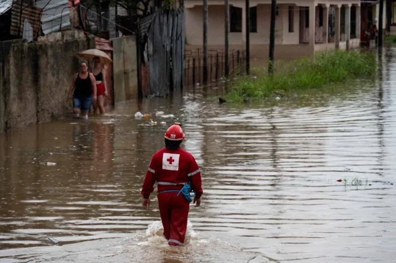A member of the Cuban Red Cross works on a flooded street in Batabano, Mayabeque province, Cuba, during the passage of tropical storm Idalia. AFP