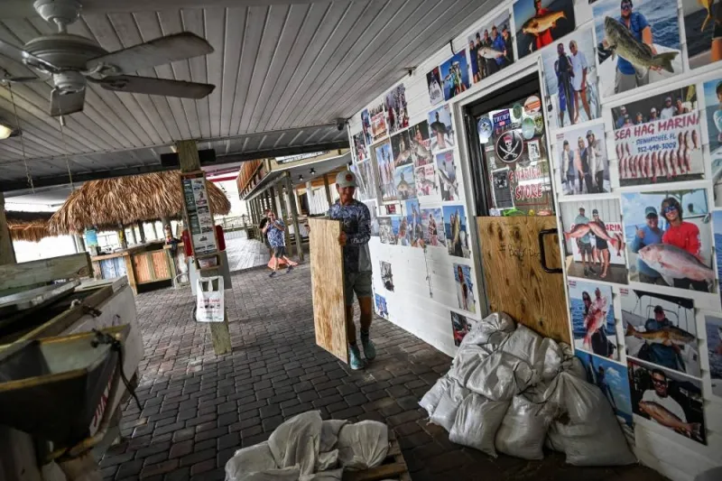 People board up their shop at a marina in Steinhatchee, Florida as preparations are made ahead of Hurricane Idalia. AFP