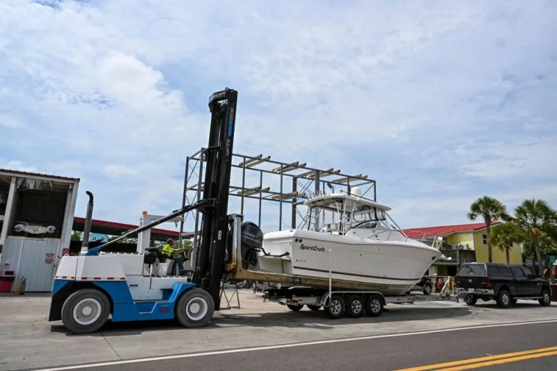 A man loads a boat at the back of a car from a marina in Steinhatchee, Florida as preparations are made ahead of Hurricane Idalia. AFP