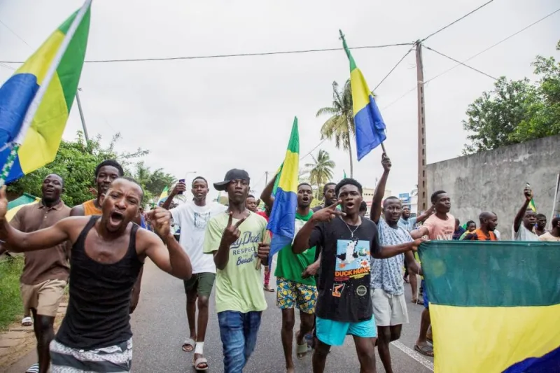 People celebrate in support of the putschists in a street of Port-Gentil, Gabon. REUTERS