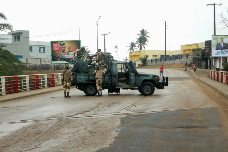 Soldiers of the Republican Guard stand on their armed pick-up in a street in Libreville. REUTERS