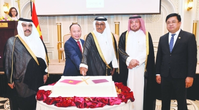 Vietnam ambassador Tran Duc Hung is joined by Qatar&#039;s Minister of Justice HE Masoud bin Mohamed al-Ameri in cutting a ceremonial cake yesterday at the function as Qatar&#039;s Ministry of Foreign Affairs&#039; Department of Protocol director Ibrahim Fakhro and other dignitaries look on. PICTURES: Shaji Kayamkulam.