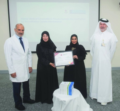 HE the Minister of Public Health Dr Hanan Mohamed al-Kuwari holds the citation along with other HMC officials.
