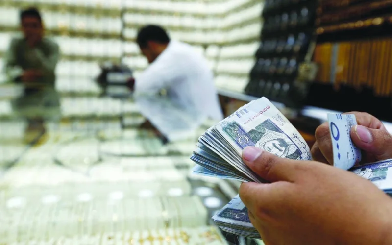 A man counts Saudi riyal banknotes in a jewellery store in Riyadh. The IMF expects Saudi non-oil growth at around 5% this year, according to its latest Article IV review of the kingdom published Wednesday.