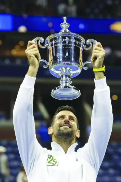 Serbia’s Novak Djokovic celebrates with the trophy after defeating Russia’s Daniil Medvedev in the US Open final in New York. (AFP)