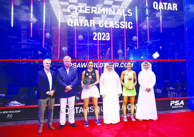 Hania El Hammamy of Egypt and compatriot Nour El Sherbini during the prize distribution ceremony following the final of the QTerminals Qatar Classic 2023 at the Khalifa Tennis and Squash Complex in Doha on Friday. Qatar Squash Federation officials and other dignitaries also attended the ceremony.