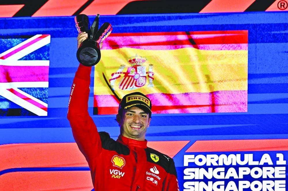 Ferrari&#039;s Spanish driver Carlos Sainz Jr celebrates on the podium after winning the Singapore Formula One Grand Prix night race at the Marina Bay Street Circuit in Singapore yesterday. (AFP)