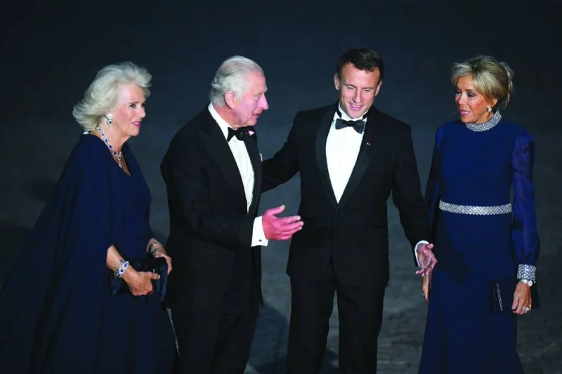 
Britain’s Queen Camilla and her husband King Charles III and French President Emmanuel Macron and his wife Brigitte Macron arrive to attend a state banquet at the Palace of Versailles yesterday on the first day of a British royal state visit to France. (Reuters) 