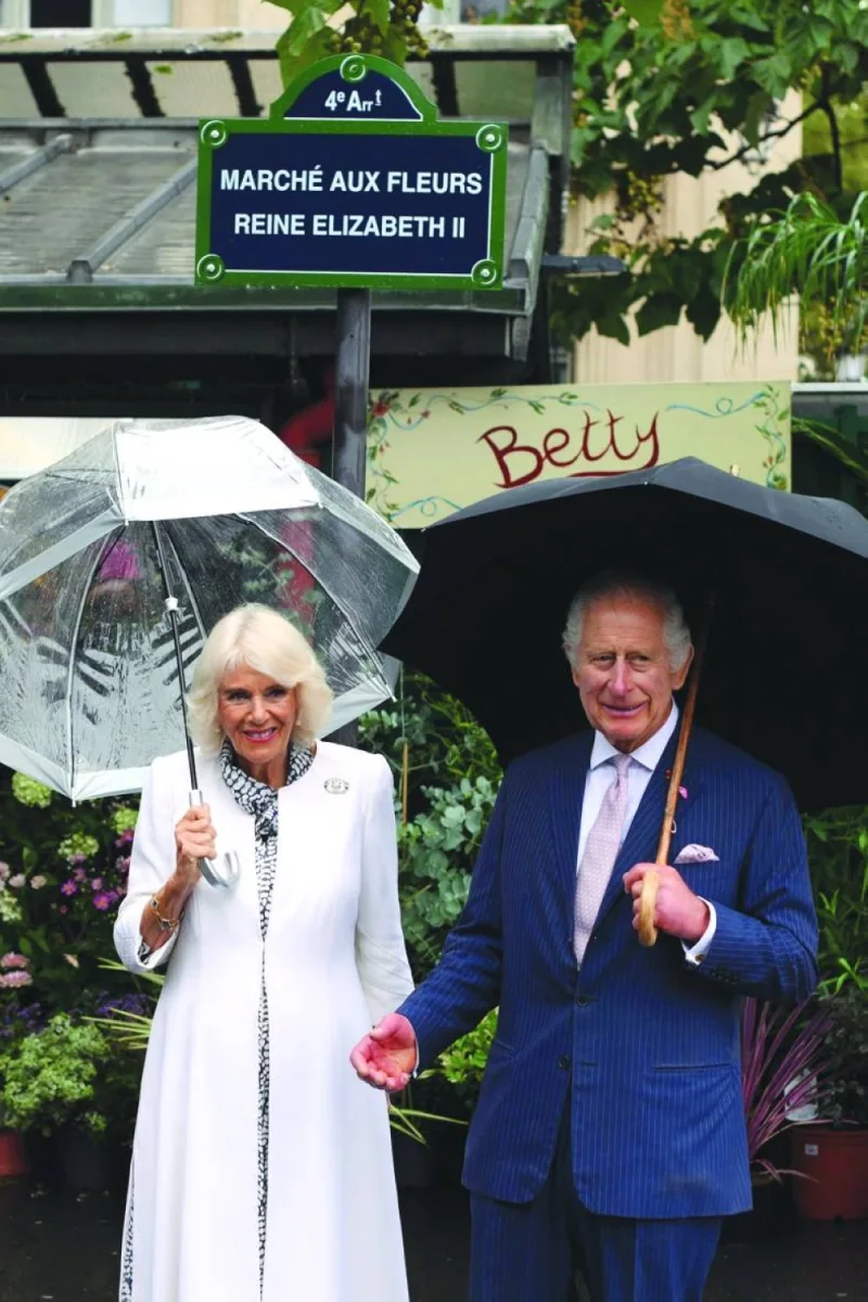 Britain’s King Charles III and his wife Queen Camilla pose as they arrive to visit the central Paris Flower Market, named after her late Majesty Queen Elizabeth during her state visit in 2014, in Paris on Thursday. (AFP)