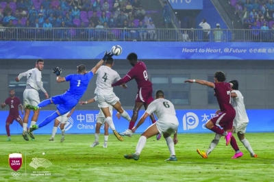 Qatar and Palestine players battle for the ball on Friday.