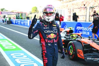 Red Bull Racing’s Dutch driver Max Verstappen celebrates after taking poll position in the qualifying session for the Formula One Japanese Grand Prix at the Suzuka circuit, Mie prefecture, on Saturday. (AFP)