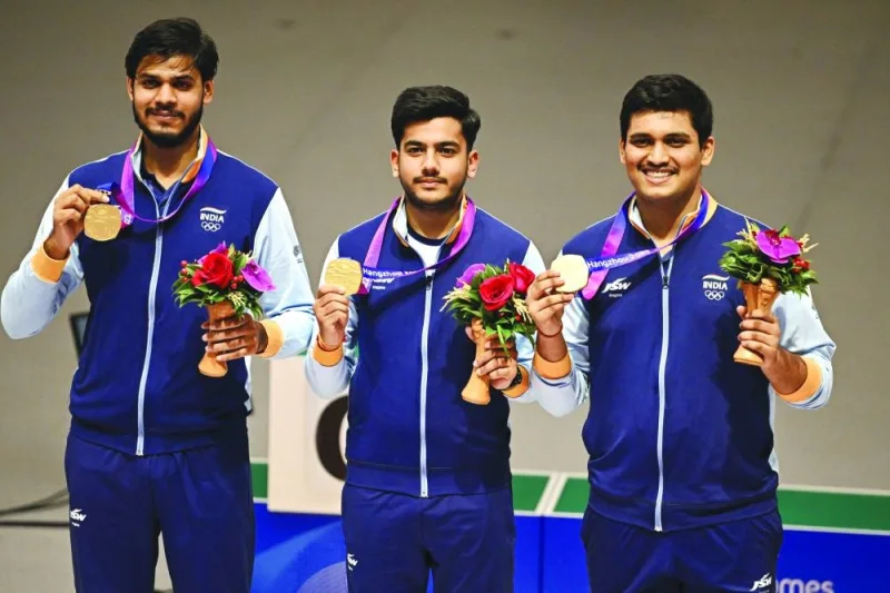 
India’s 10m air rifle team gold medallists Divyansh Singh Panwar (left), Aishwary Pratap Singh Tomar (centre) and Rudrankksh Patil pose on the podium at the Fuyang Yinhu Sports Centre in Hangzhou, China. (AFP) 