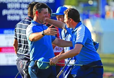 Europe’s Northern Irish golfer Rory McIlroy (left) and Europe’s English golfer Matt Fitzpatrick celebrate after victory in their four-ball match on the first day of play in the 44th Ryder Cup at the Marco Simone Golf and Country Club in Rome on Friday. (AFP)