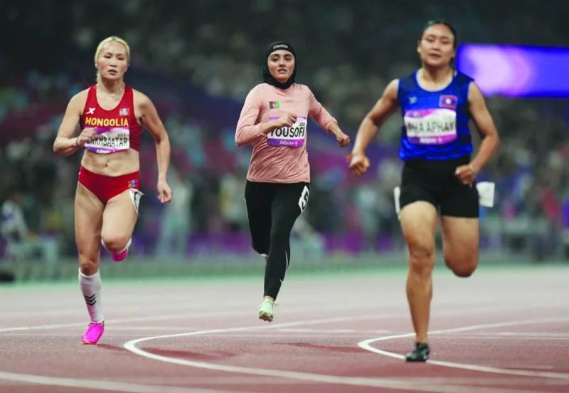 
Afghanistan’s Kimia Yousofi (centre) competes in the women’s 100m heats during the Hangzhou Asian Games at the Olympic Sports Centre Stadium in Hangzhou, China. (Reuters) 