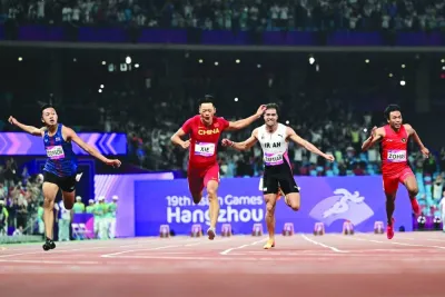 China’s Xie Zhenye (second left) sprints to victory in the men’s 100m final during the Asian Games in Hangzhou on Saturday. (AFP)