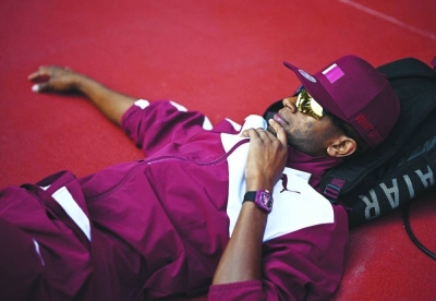 Qatar’s high jump legend Mutaz Barshim takes his usual relaxing posture before competing in the qualification at the Hangzhou Asian Games yesterday. (Reuters)