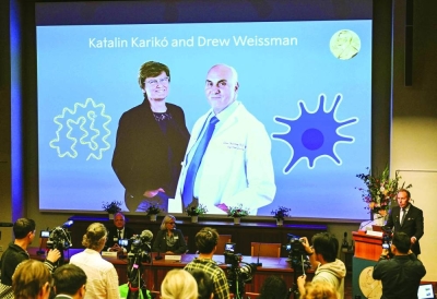 
A screen shows this year’s laureates Katalin Kariko of Hungary (left) and Drew Weissman of the US during the announcement of the winners of the 2023 Nobel Prize in Physiology or Medicine at the Karolinska Institute in Stockholm. 
