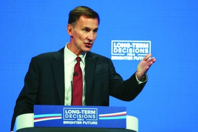 
British Chancellor of the Exchequer Jeremy Hunt speaks on stage at Britain’s Conservative Party’s annual conference in Manchester. 