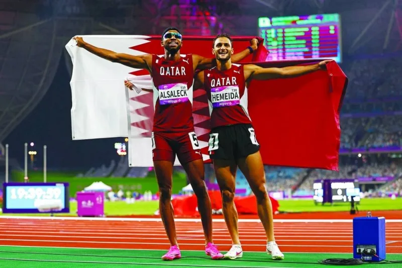 Qatar&#039;s Abderrahman Samba and Qatar&#039;s Bassem Hemeida celebrate after winning the Men&#039;s 400m Hurdles Final. REUTERS