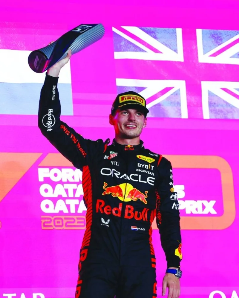 First placed Max Verstappen of Red Bull celebrates with his trophy on the podium after the race. REUTERS