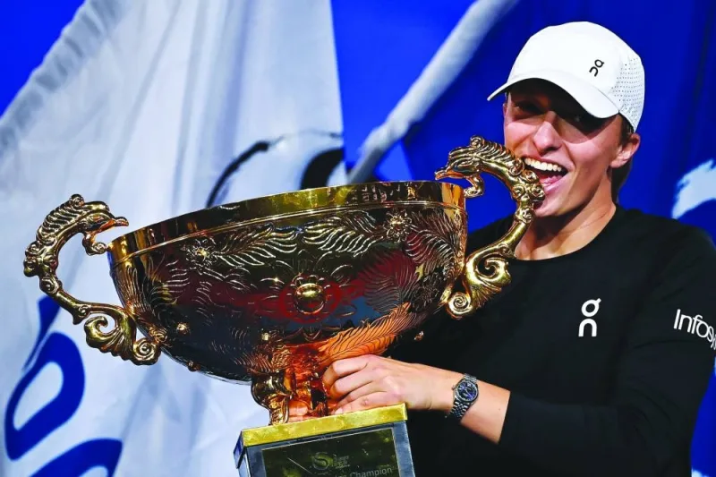 
Poland’s Iga Swiatek, the world No .2, holds the trophy after defeating Russia’s Liudmila Samsonova in the final of the WTA China Open in Beijing yesterday. (AFP) 