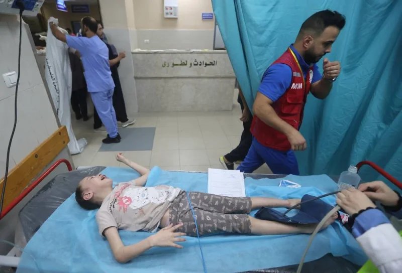 A Palestinian child, wounded in Israeli strikes lies on a bed at a hospital in Khan Younis in the southern Gaza strip, Monday. REUTERS