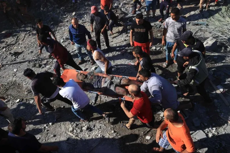 A Palestinian youth is stretchered away after being pulled out from under the rubble of a building following an Israeli airstrike in Rafah, in the southern of Gaza Strip, Monday. AFP