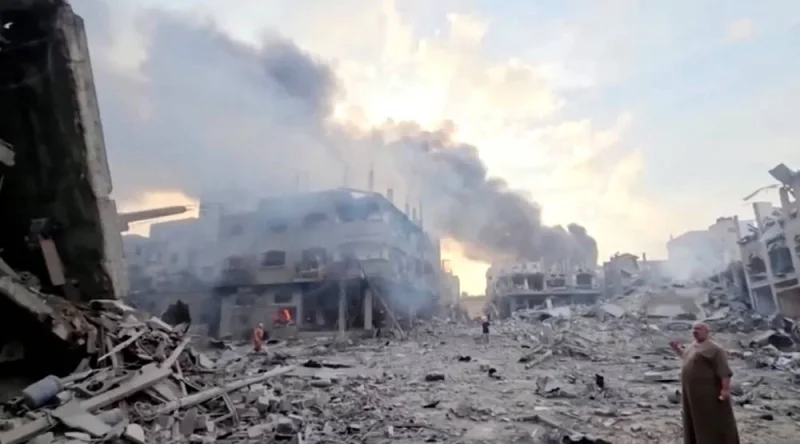People survey the destruction at Gaza&#039;s Jabalia refugee camp, following Israeli strikes on the enclave, in this still image from video obtained by REUTERS.