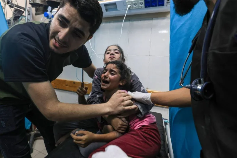 Children injured in an Israeli air strike react as they receive treatment in the Nasser hospital in Khan Yunis in the southern of Gaza Strip, Tuesday. AFP