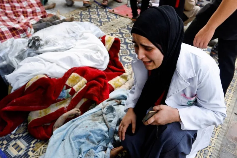  A woman reacts next to bodies of Palestinians killed in Israeli strikes, at a hospital in the southern Gaza Strip, Tuesday. REUTERS