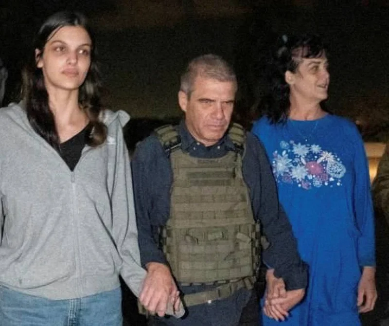Judith Tai Raanan and her daughter Natalie Shoshana Raanan, US citizens who were taken as hostages by Palestinian Hamas militants, walk while holding hands with Brig-Gen. (Ret.) Gal Hirsch, Israel&#039;s Coordinator for the Captives and Missing, after they were released, in response to Qatari mediation efforts. Government of Israel/Handout via REUTERS