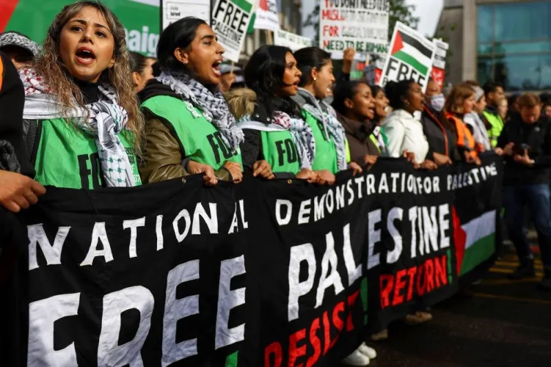Demonstrators hold a banner, at a protest in solidarity with Palestinians in Gaza, amid the ongoing conflict between Israel and the Palestinian group Hamas, in London, Saturday. REUTERS