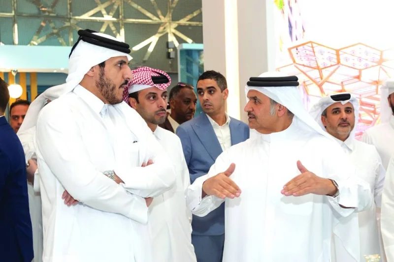 HE the Minister of Commerce and Industry Sheikh Mohamed bin Hamad bin Qassim al-Abdullah al-Thani listens to a briefing by Ibrahim Jassim al-Othman, UDC president and CEO, and member of the board, during the opening of Cityscape Qatar 2023 Tuesday.