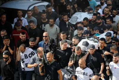 Mourners carry bodies of Palestinians who were killed in an Israeli raid, at the Jenin refugee camp, in Jenin in the Israeli-occupied West Bank, , Wednesday. REUTERS
