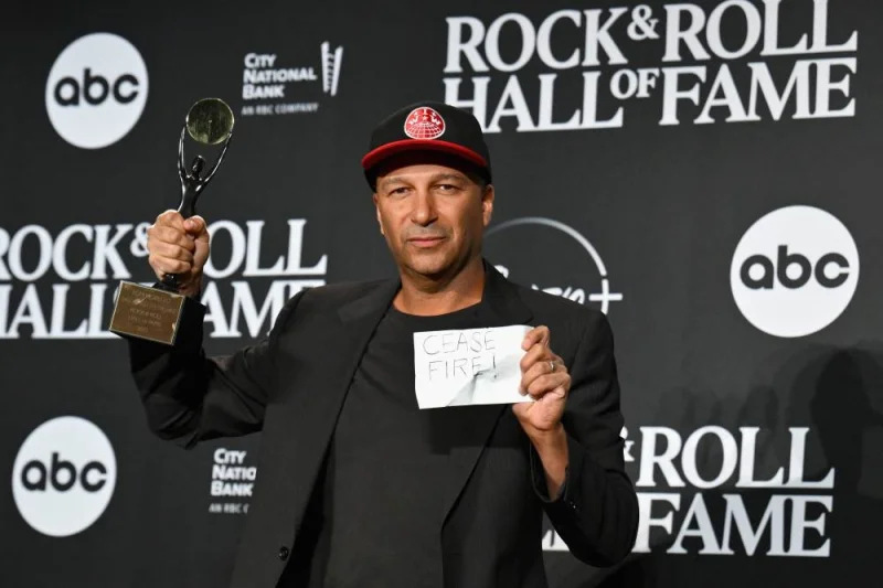 
Inductee US guitarist Tom Morello of “Rage Against The Machine” poses in the press room with a paper reading “cease fire” during the 38th Annual Rock & Roll Hall of Fame Induction Ceremony at Barclays Center in the Brooklyn borough of New York City. (AFP) 