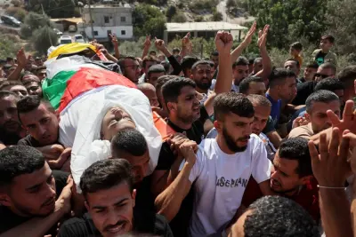  Mourners carry the body of Palestinian Ahmad Dababseh who was killed in an Israeli raid, during his Funeral in Nuba near Hebron in the Israeli-occupied West Bank, Sunday. REUTERS