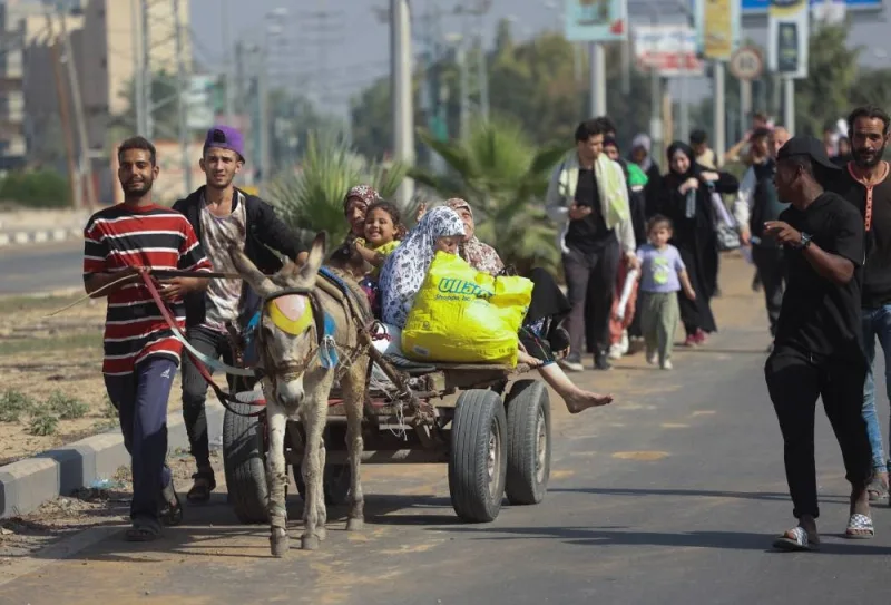 Palestinian civilians ride a donkey-drawn cart as they evacuate from the north of the Gaza Strip towards south, in the central Gaza Strip on Tuesday. REUTERS
