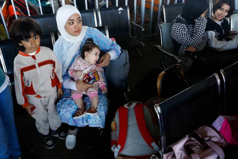 Palestinians with foreign passports wait for permission to leave Gaza, at the Rafah border crossing with Egypt, in Rafah in the southern Gaza Strip, on Tuesday. REUTERS