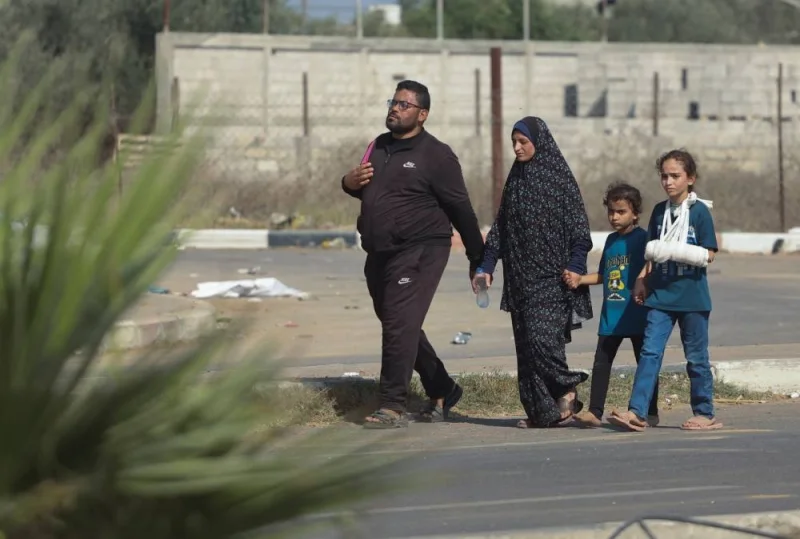 Palestinian civilians walk while evacuating from the north of the Gaza Strip towards south, on Tuesday. REUTERS