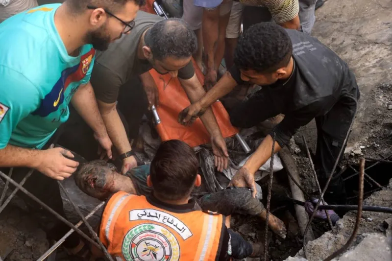 Palestinians recover the body of a child from the rubble of a building, in Khan Yunis on Tuesday. AFP